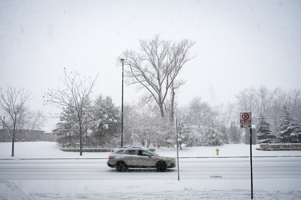 a car driving down a snow covered road