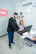 Smiling professional woman in a dental office, representing a satisfied client.