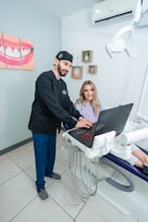 Smiling patient receiving a dental implant consultation with a dentist.