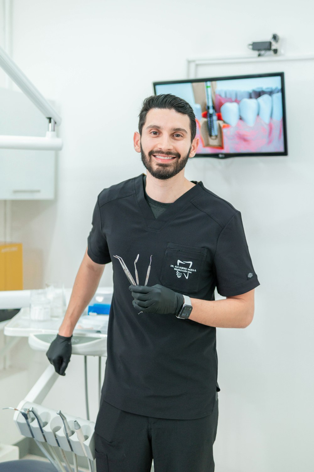 a man in a dentist's office holding a pair of scissors