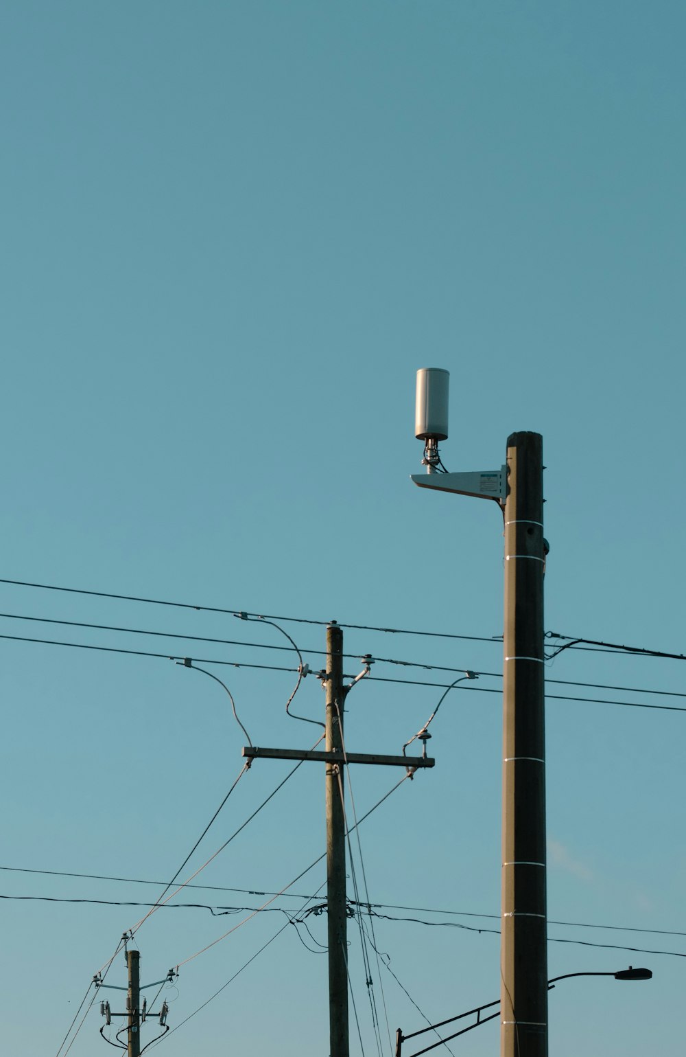 a telephone pole with a camera on top of it