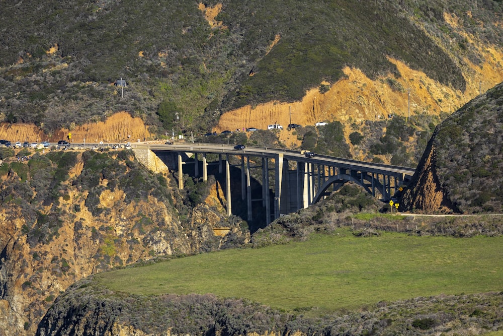 a large bridge over a lush green hillside