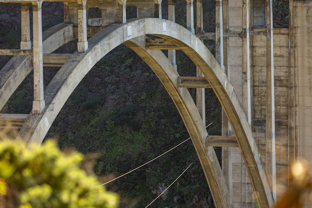 a man riding a surfboard on top of a bridge