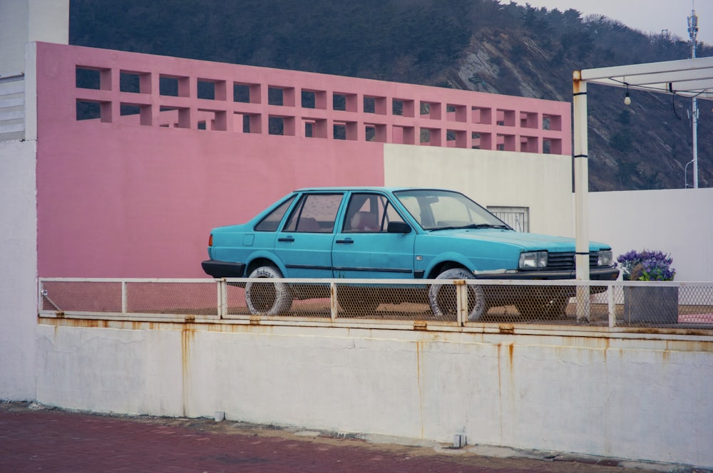 a blue car parked on the side of a road