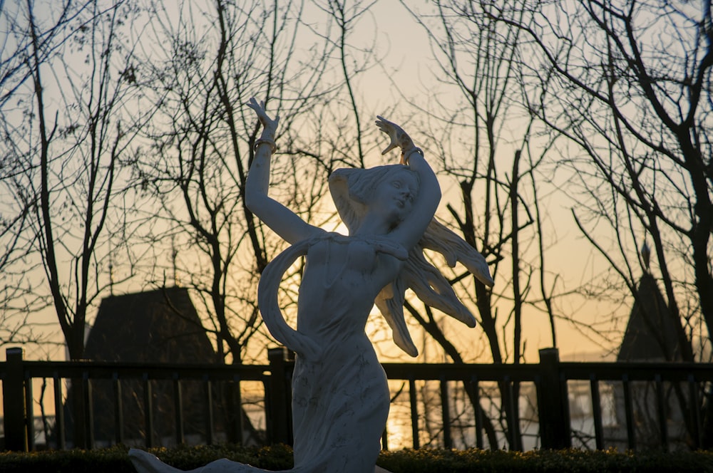 uma estátua de uma mulher segurando um pássaro em sua mão