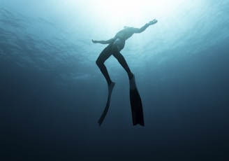 a woman is diving in the water