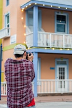 A professional photographer taking pictures of a stylish coastal rental home.