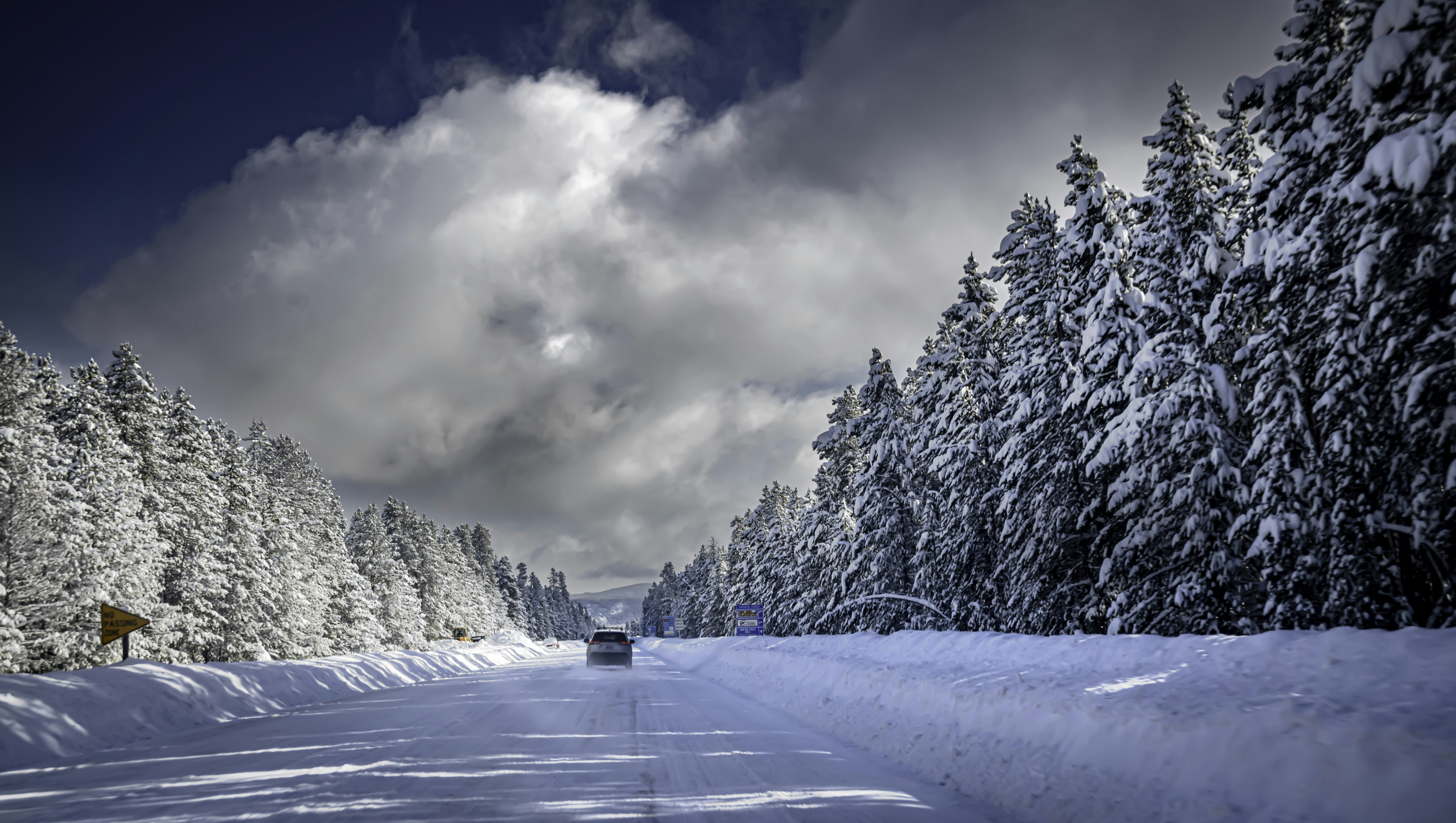 a car driving down a snow covered road, 