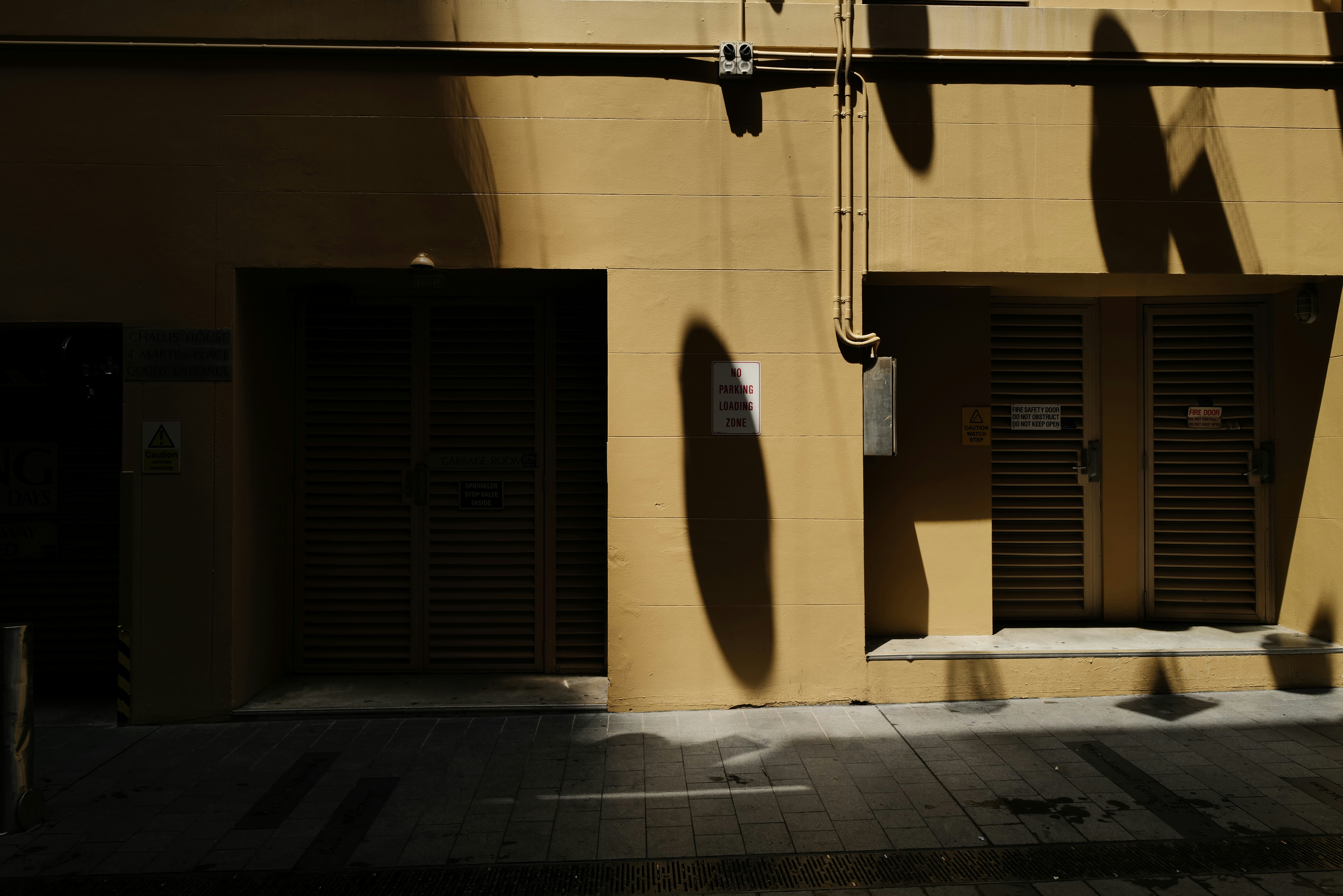 the shadow of a person on the side of a building