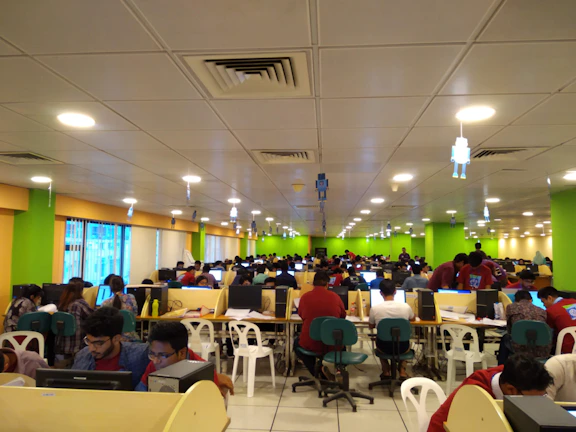 Interior view of a modern call center room with people handling calls efficiently.