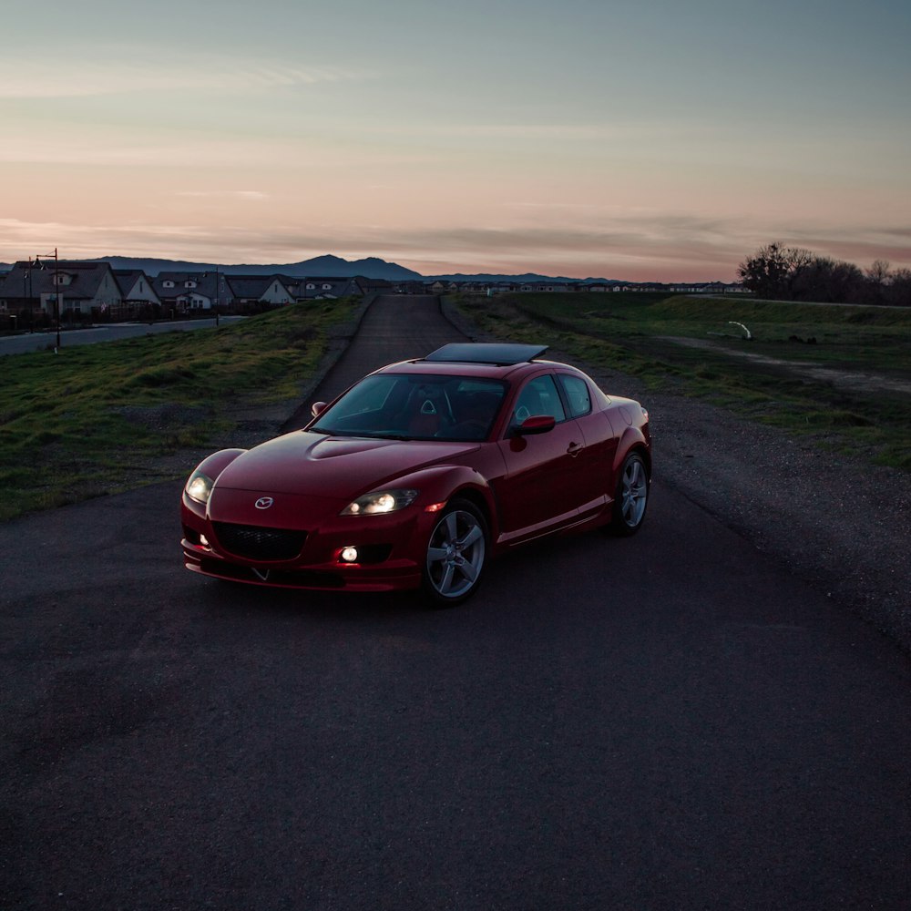 a red sports car parked on the side of a road