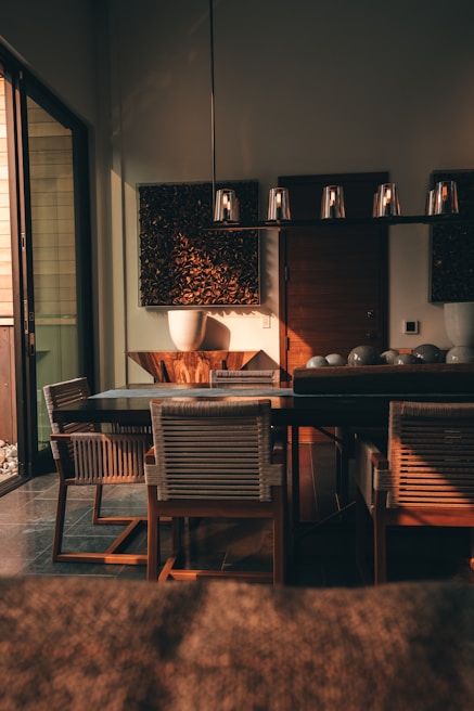 An inviting dining area with a wooden table and soft lighting.
