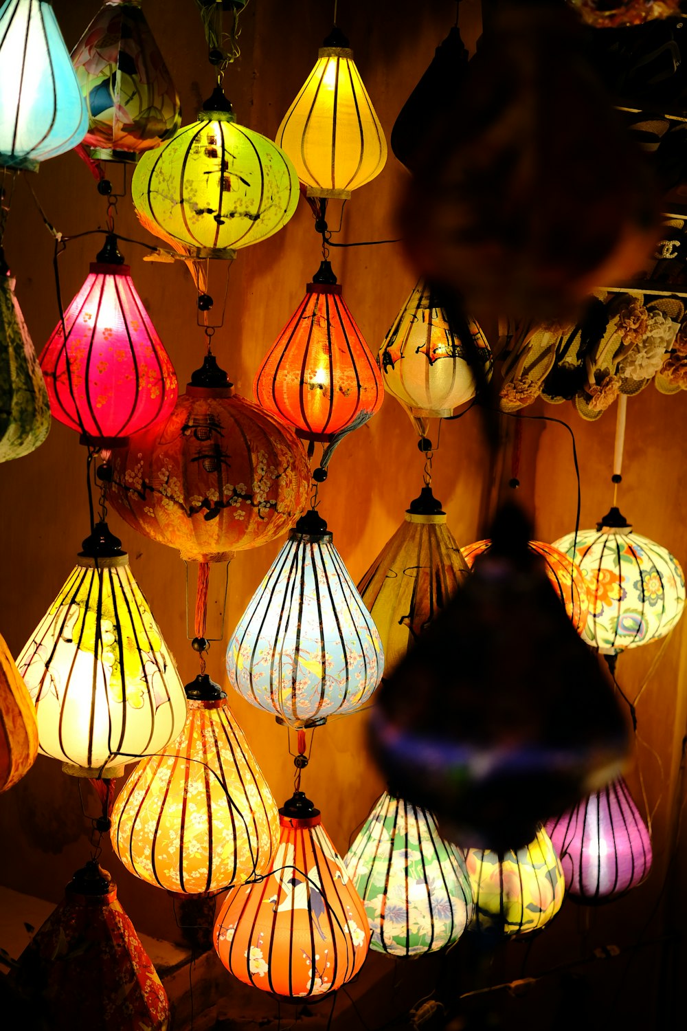 a bunch of colorful lights hanging from a ceiling