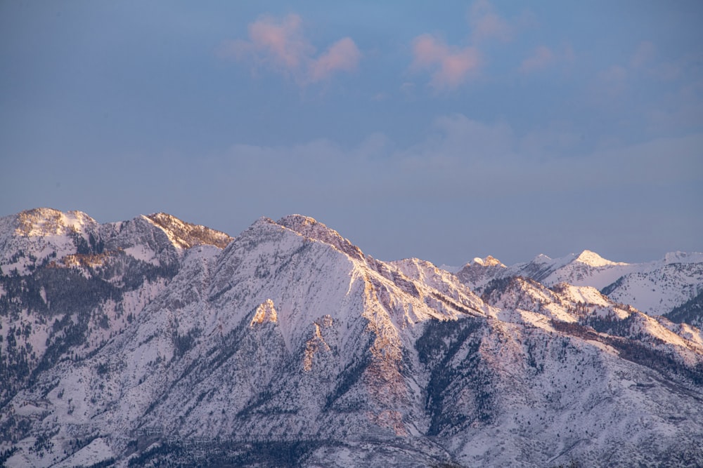 a view of a mountain range covered in snow