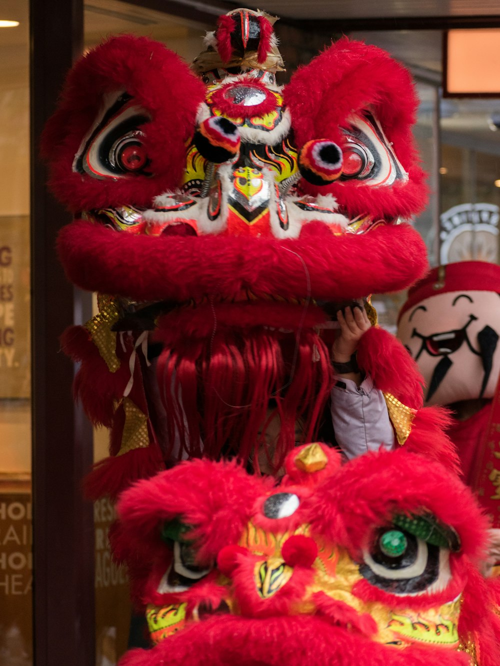 a red and yellow lion head on display in a store window