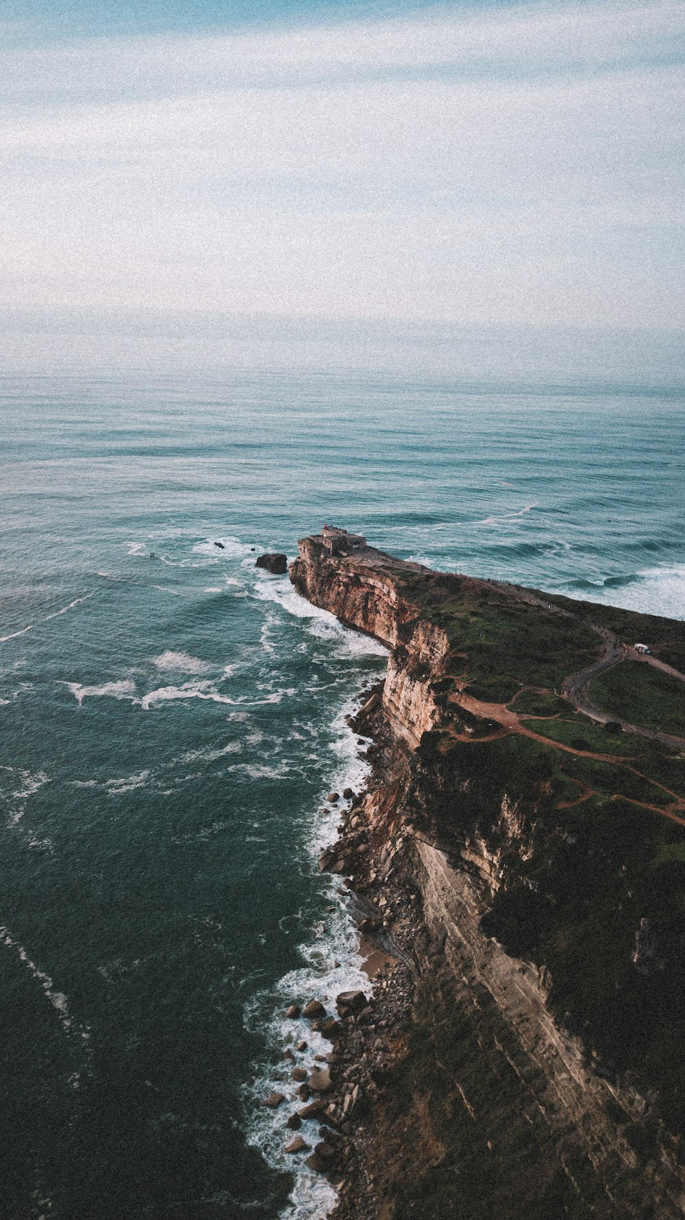 a view of the ocean from the top of a hill