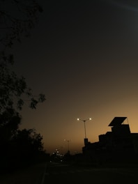 Dark overlay image of Neuquén cityscape at dusk with modern buildings and calm streets.