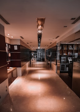 A clean, well-lit communal hallway with polished floors and tidy staircases.