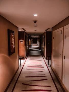 Elegant hotel corridor with subtle amber accents and soft lighting.