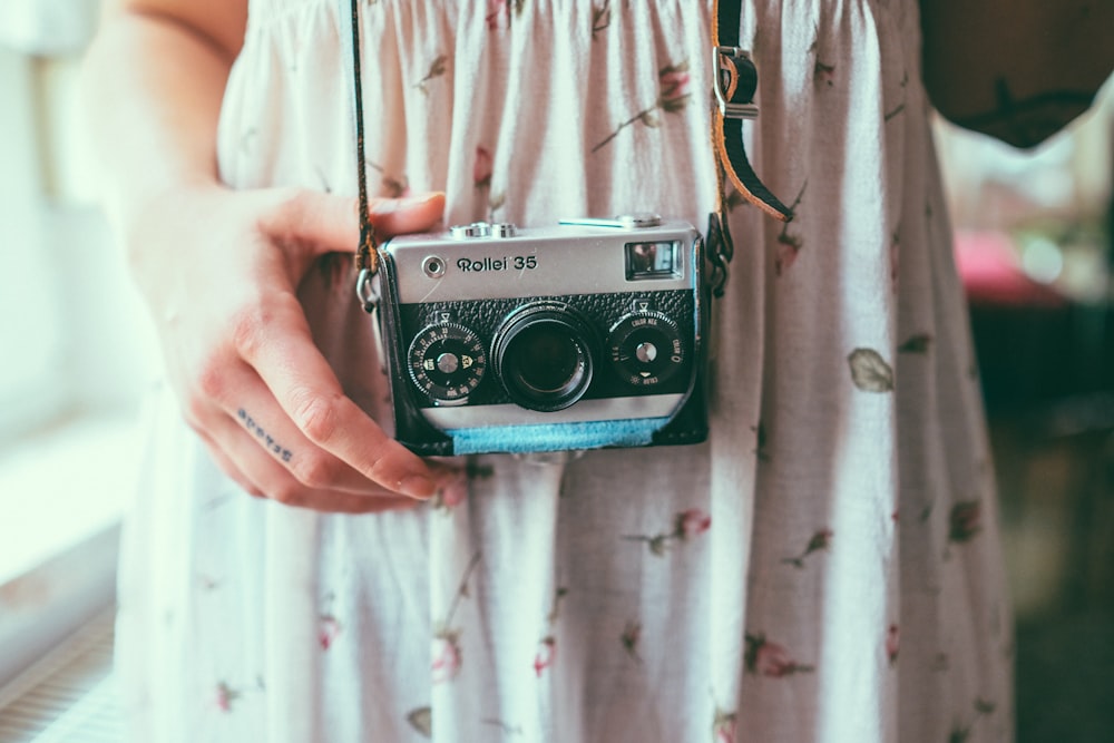 a woman holding a camera in her hand