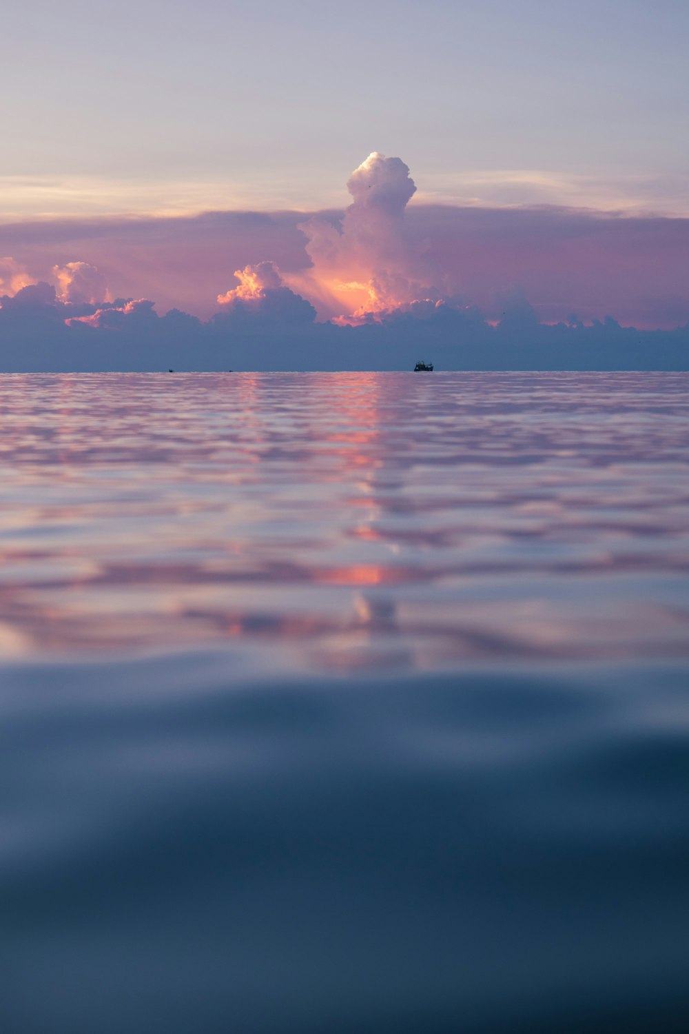 a large body of water under a cloudy sky