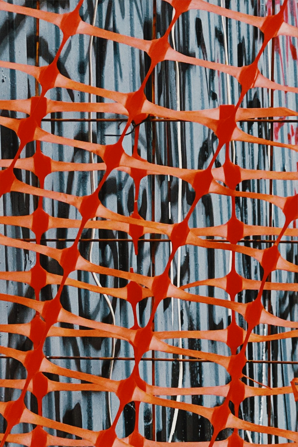 a close up of an abstract painting with orange strips