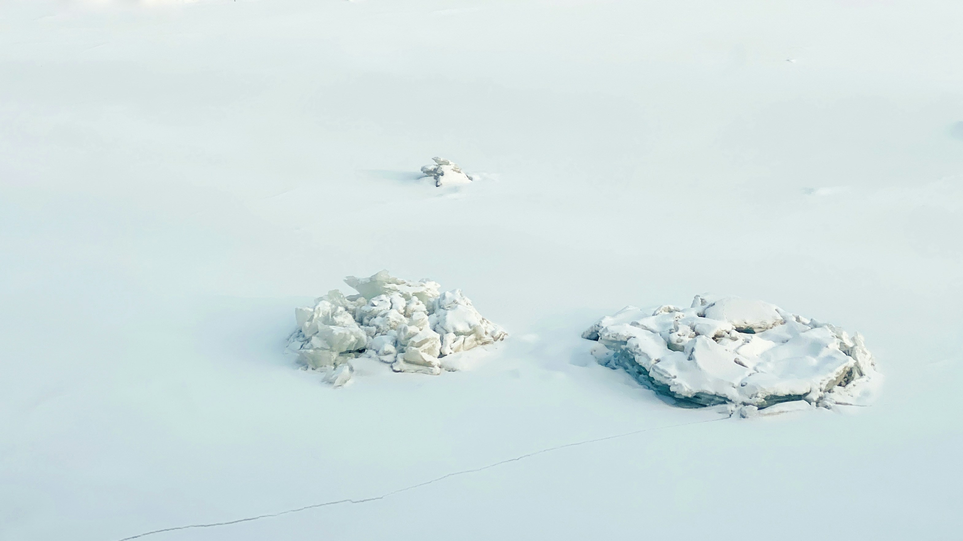 a couple of rocks that are in the snow