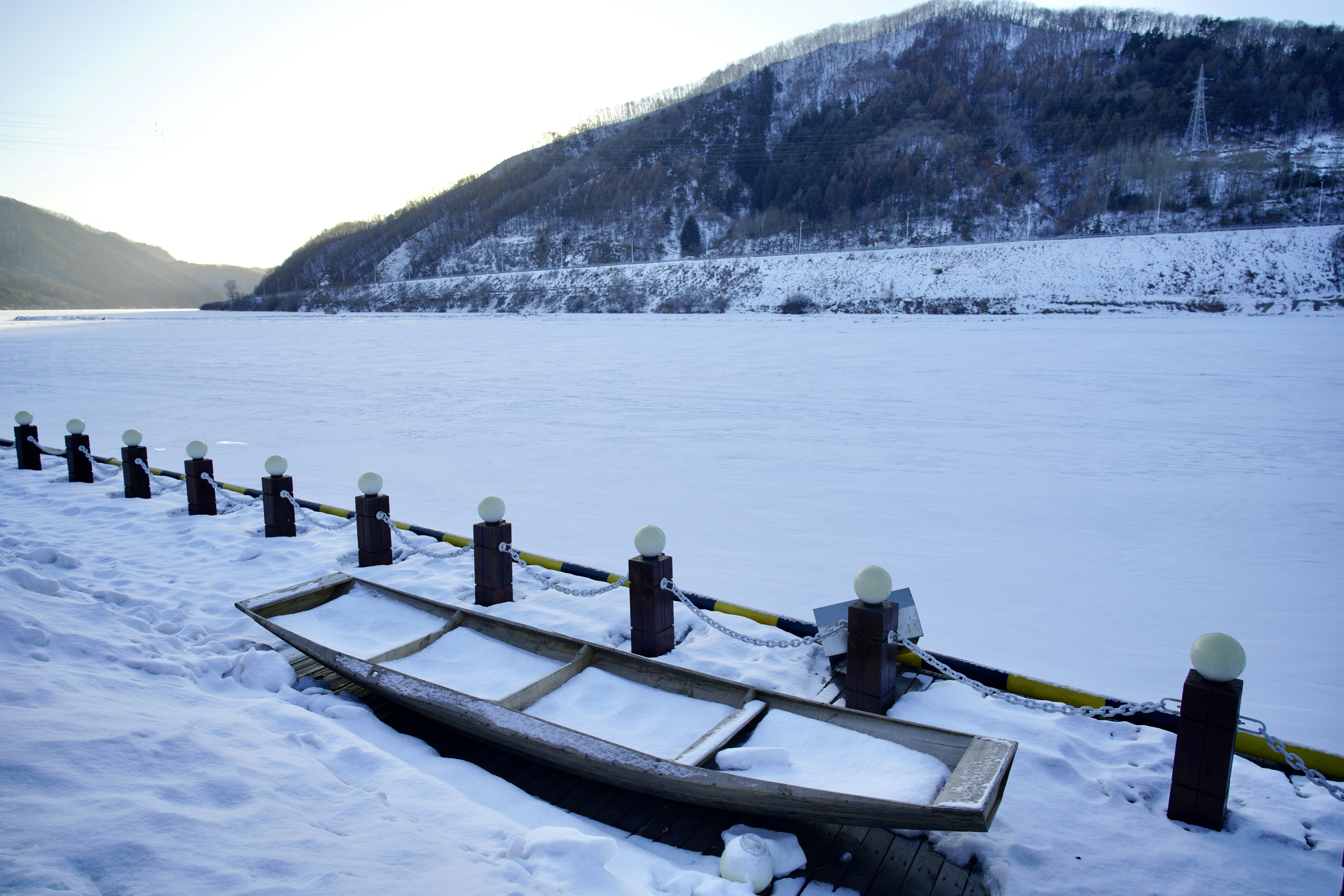 a row boat sitting on top of snow covered ground