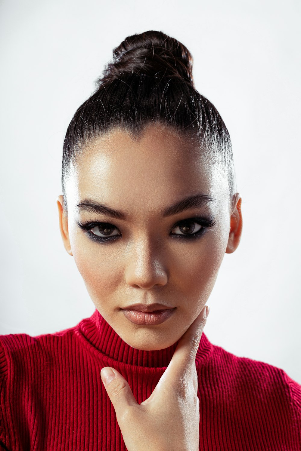 a woman in a red sweater is posing for a picture