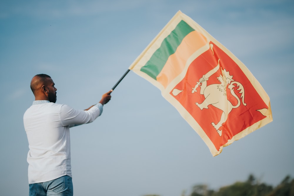 a man holding a flag with a lion on it