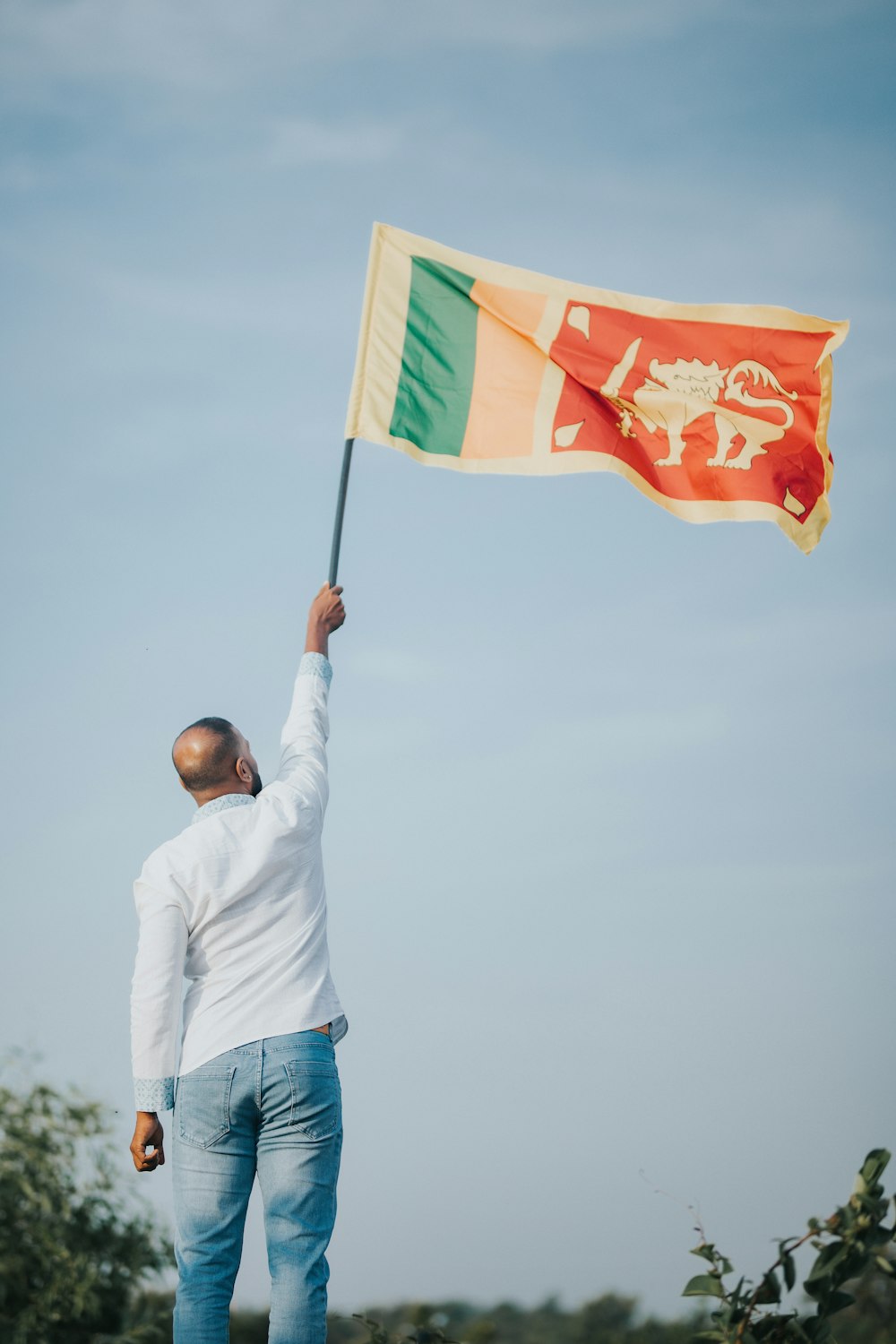 a man holding a flag in the air