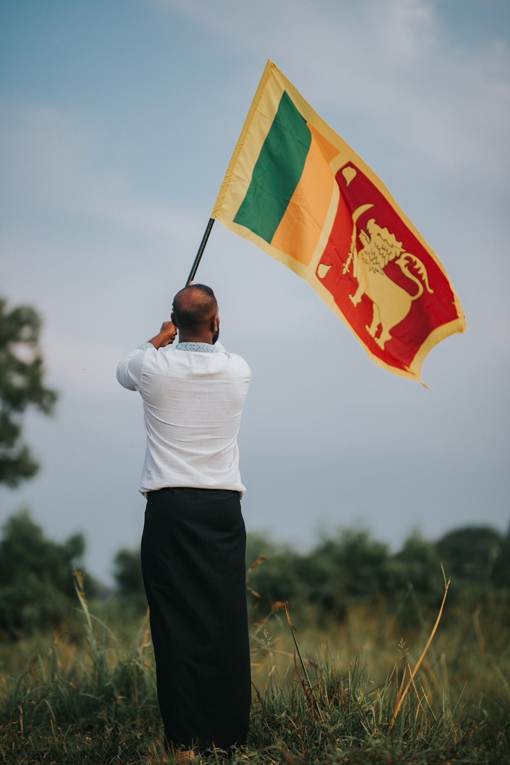 a man holding a flag in a field