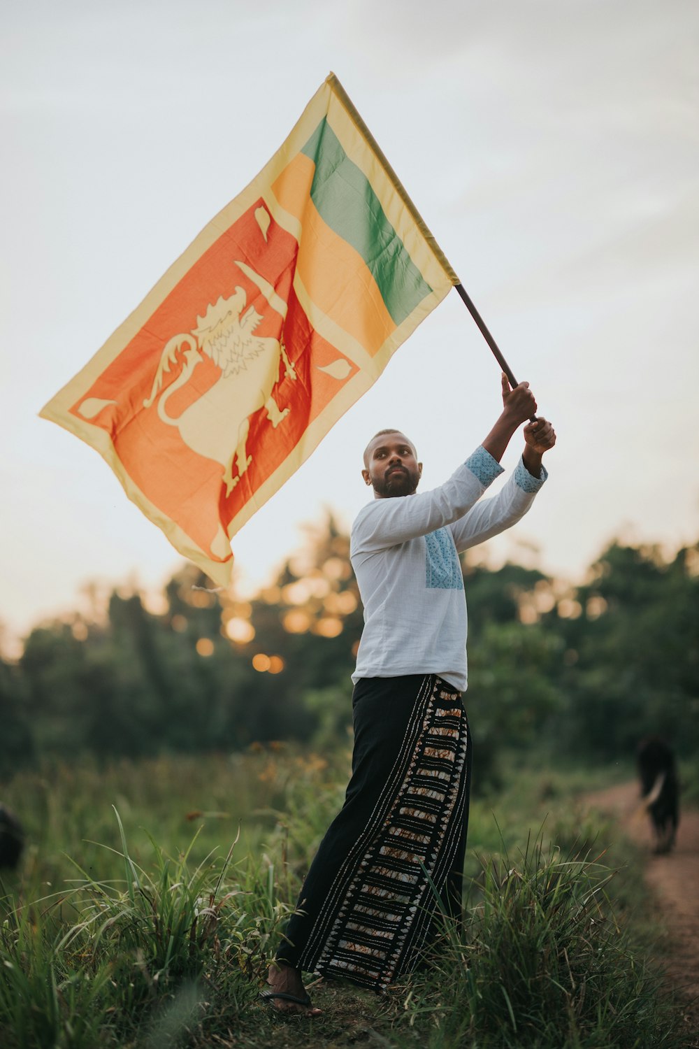 a man holding a flag in a field