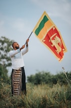 a man holding a flag in a field