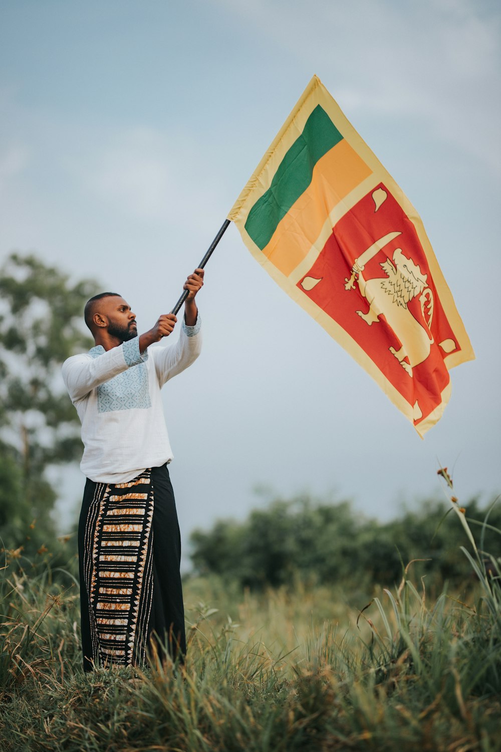 a man holding a flag in a field