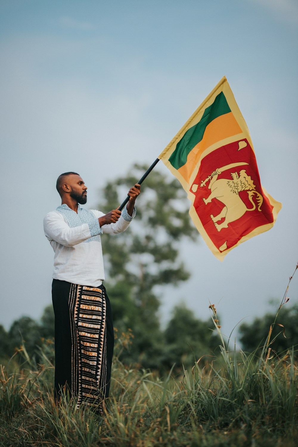 a man holding a flag in a field