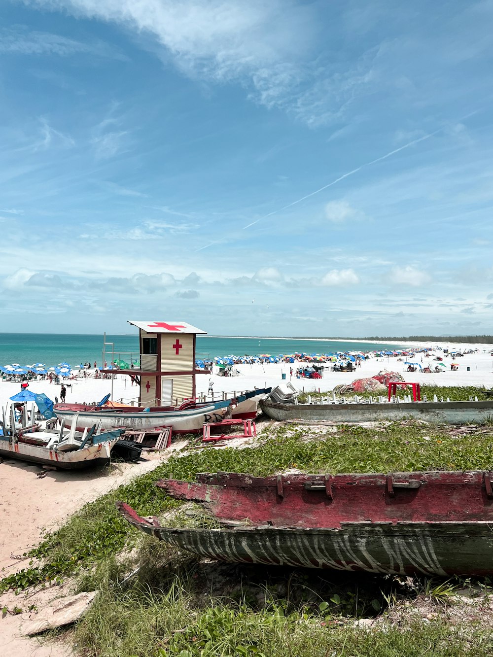 a beach with boats and people on it