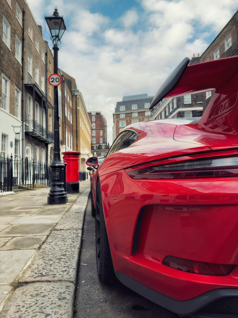 a red sports car parked on the side of the road