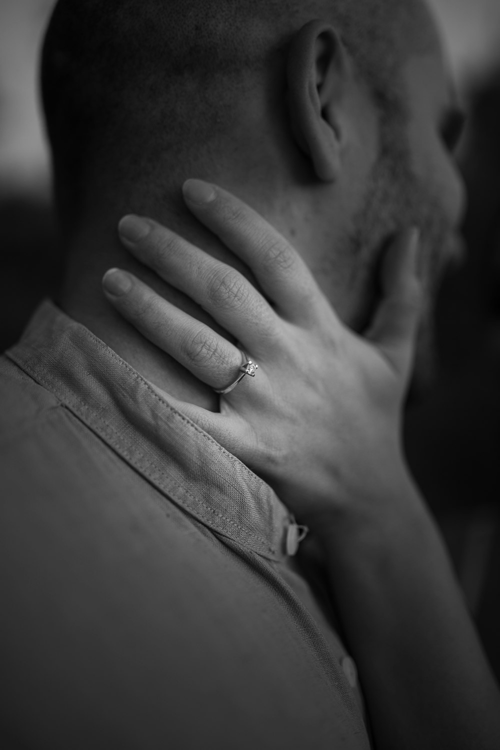 a close up of a person with a ring on their neck