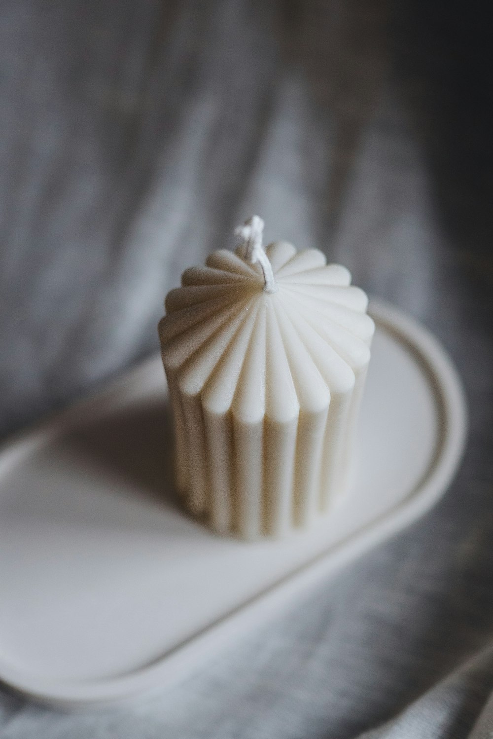 a white cupcake sitting on top of a white plate