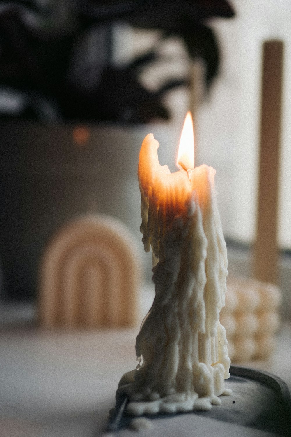 a lit candle sitting on top of a table