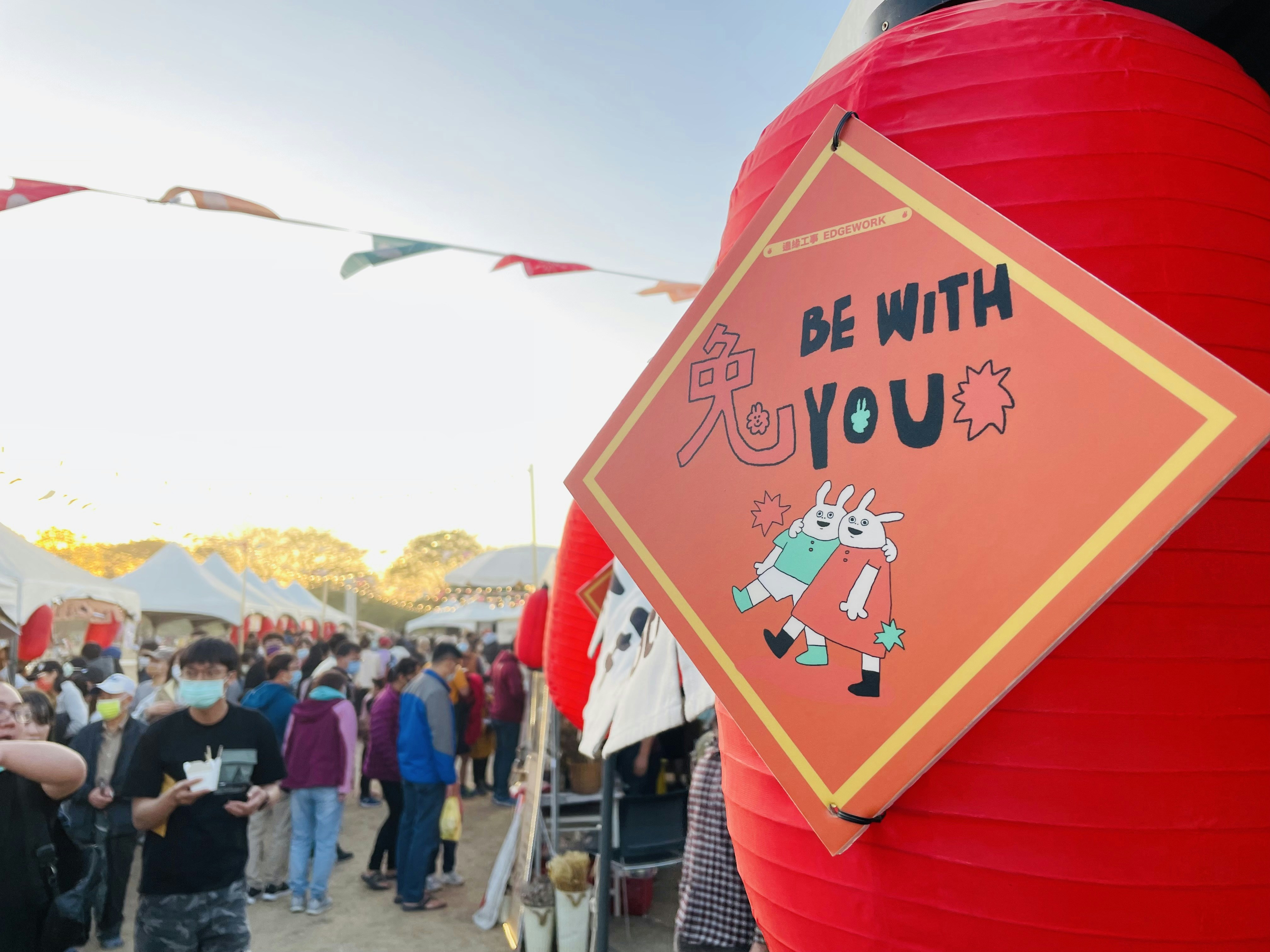 a sign that says be with you in front of a crowd of people