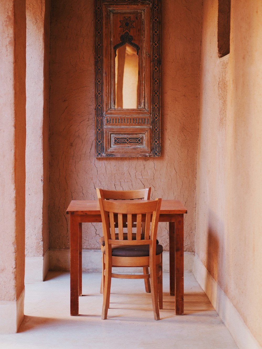 a wooden table and chair in a room