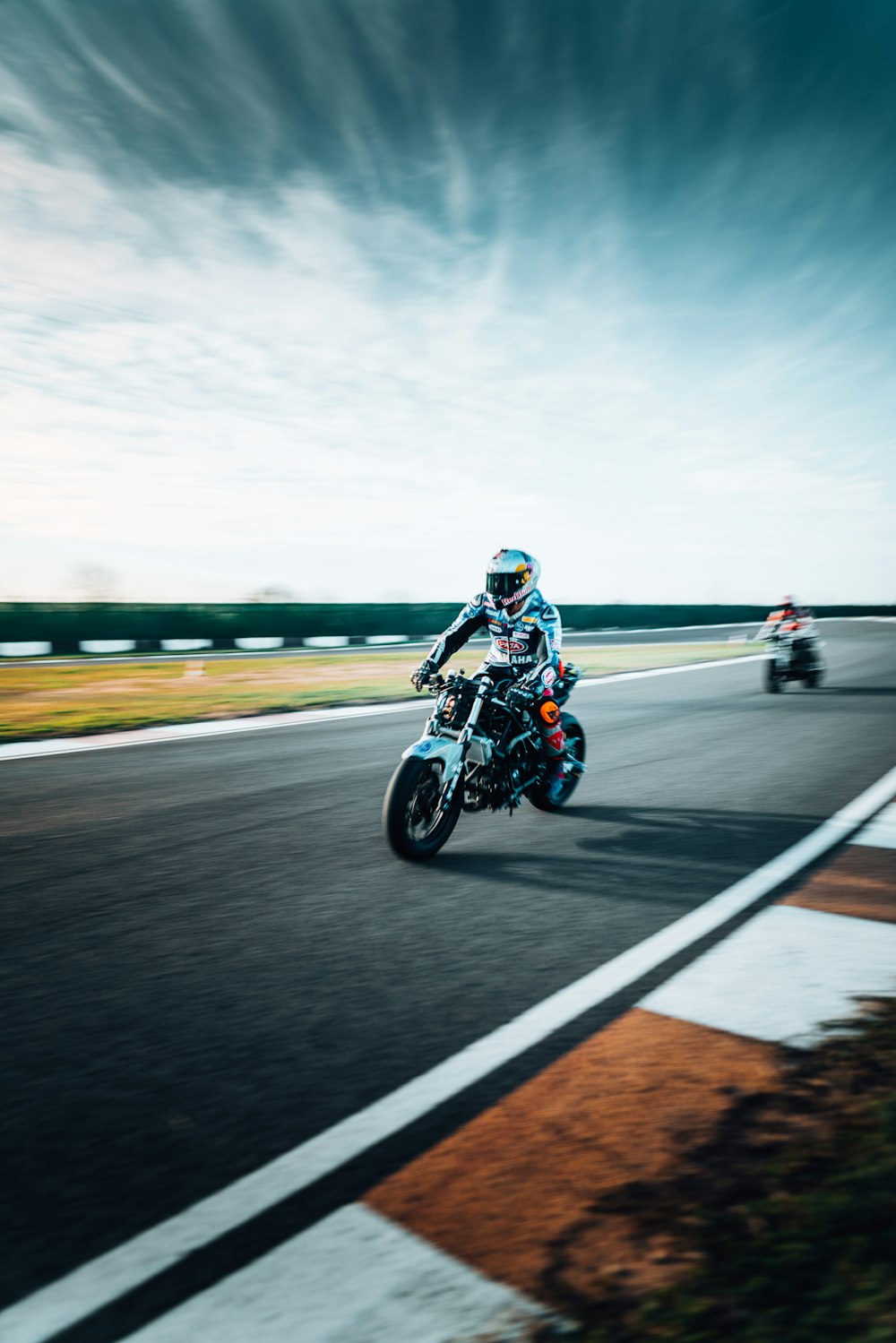 a man riding a motorcycle down a curvy road