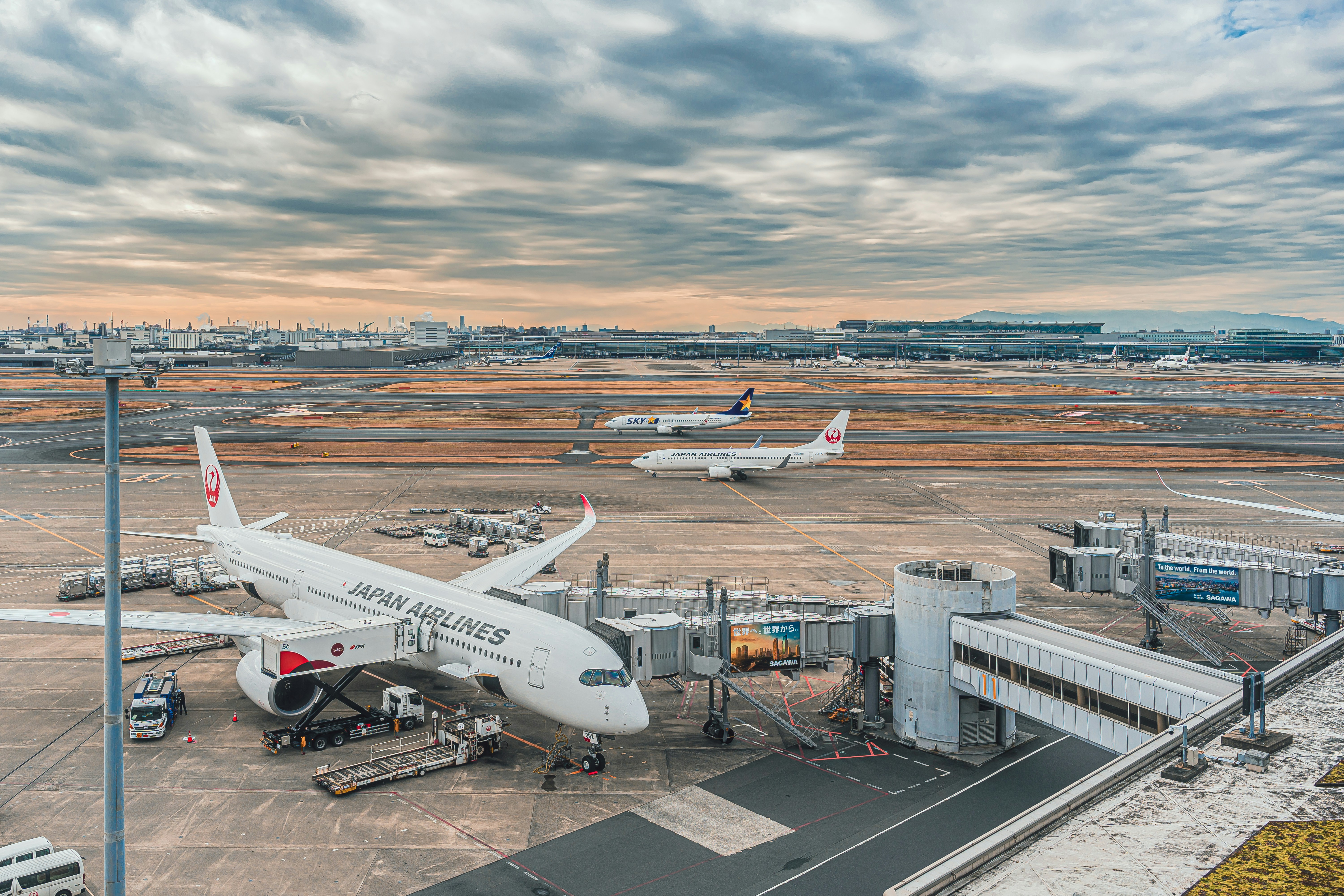 a large jetliner sitting on top of an airport tarmac, 
