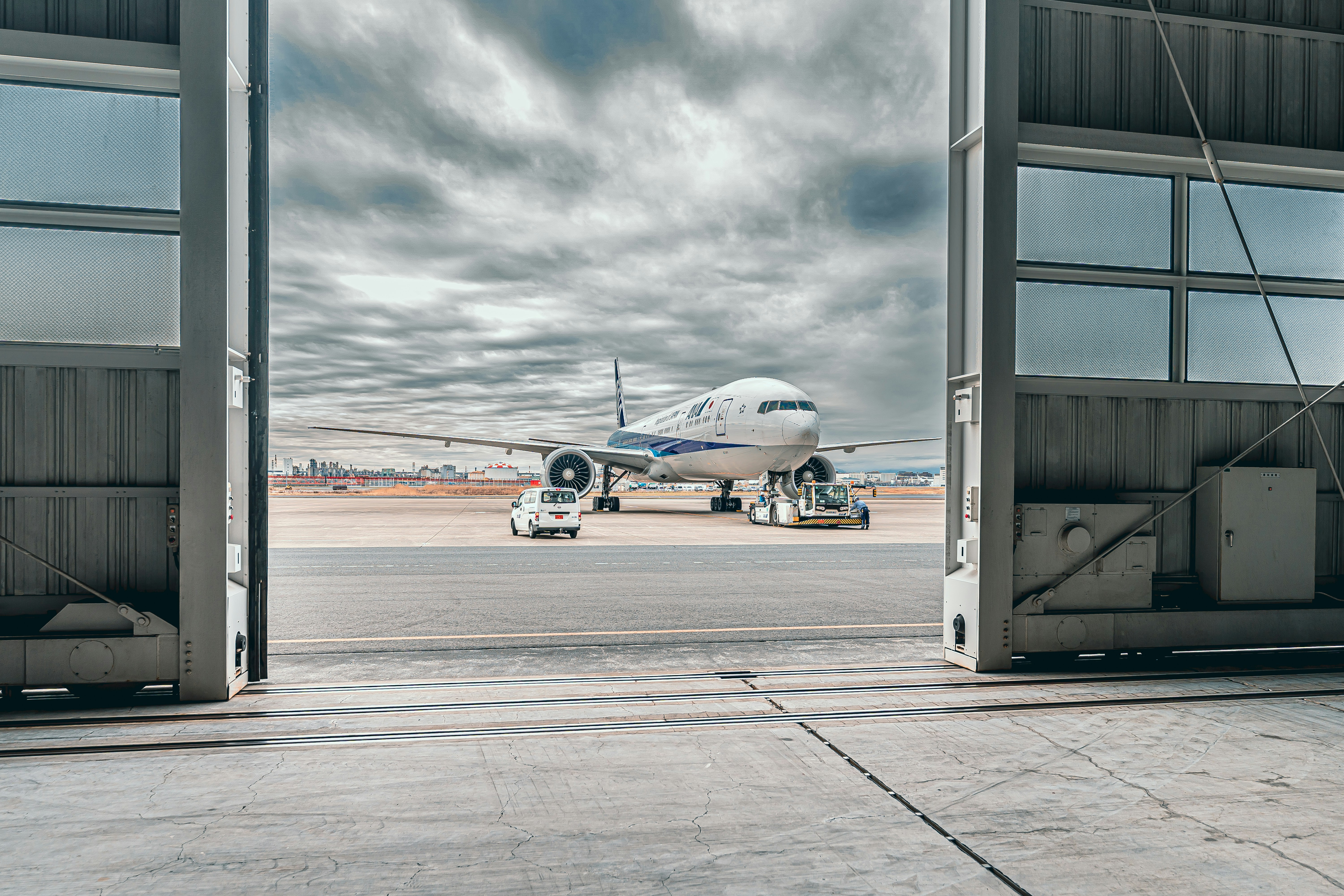 a large jetliner sitting on top of an airport tarmac, 