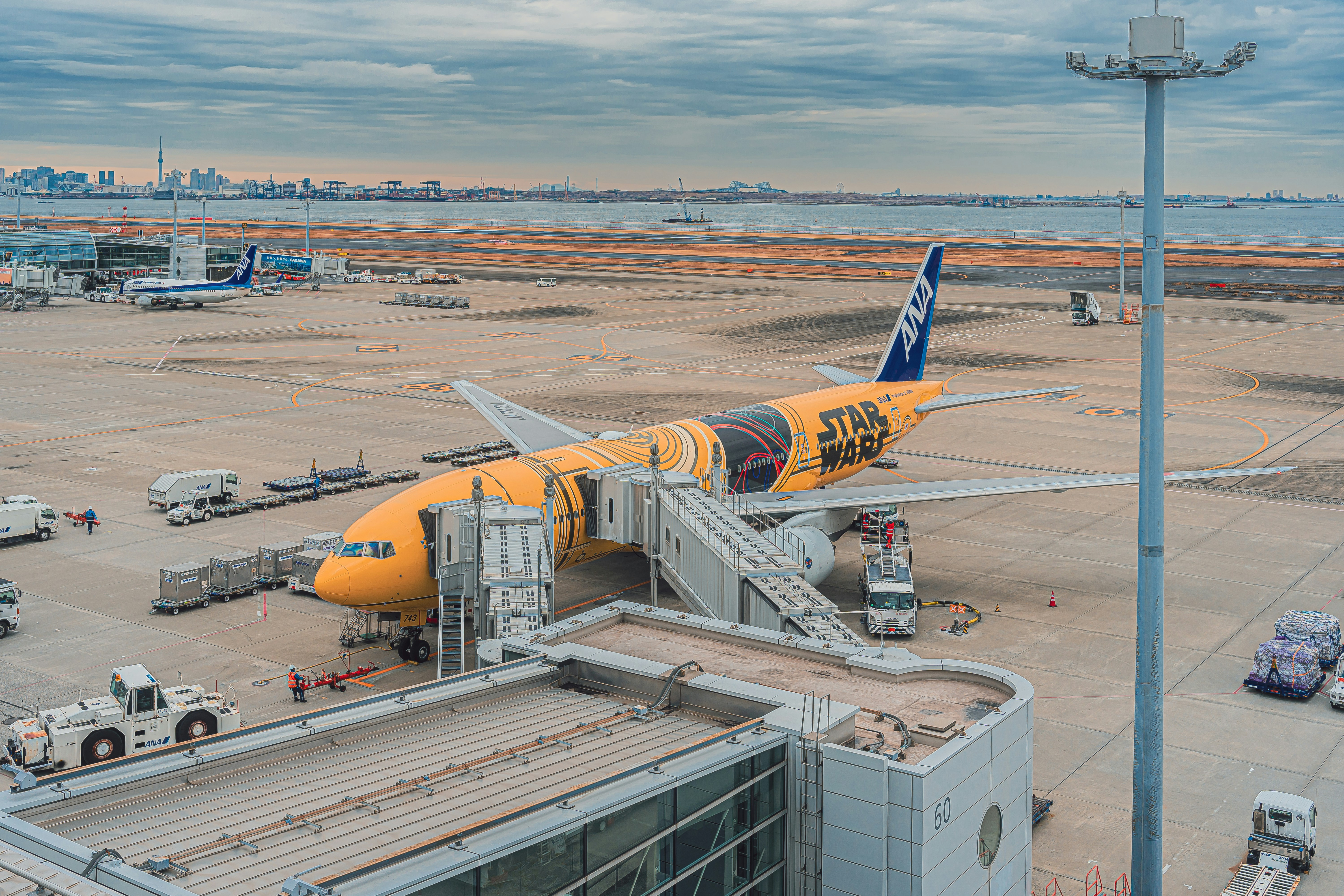 a large jetliner sitting on top of an airport tarmac, 
