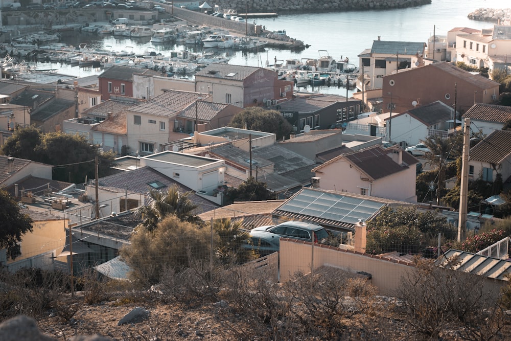 a view of a city with lots of houses and a body of water