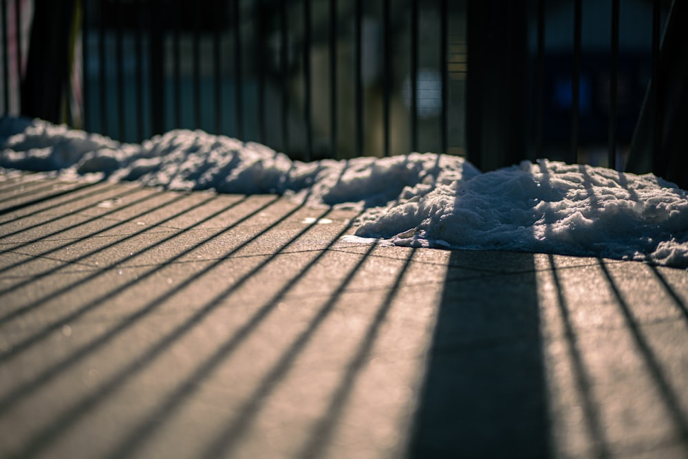 the shadow of a fence on the ground