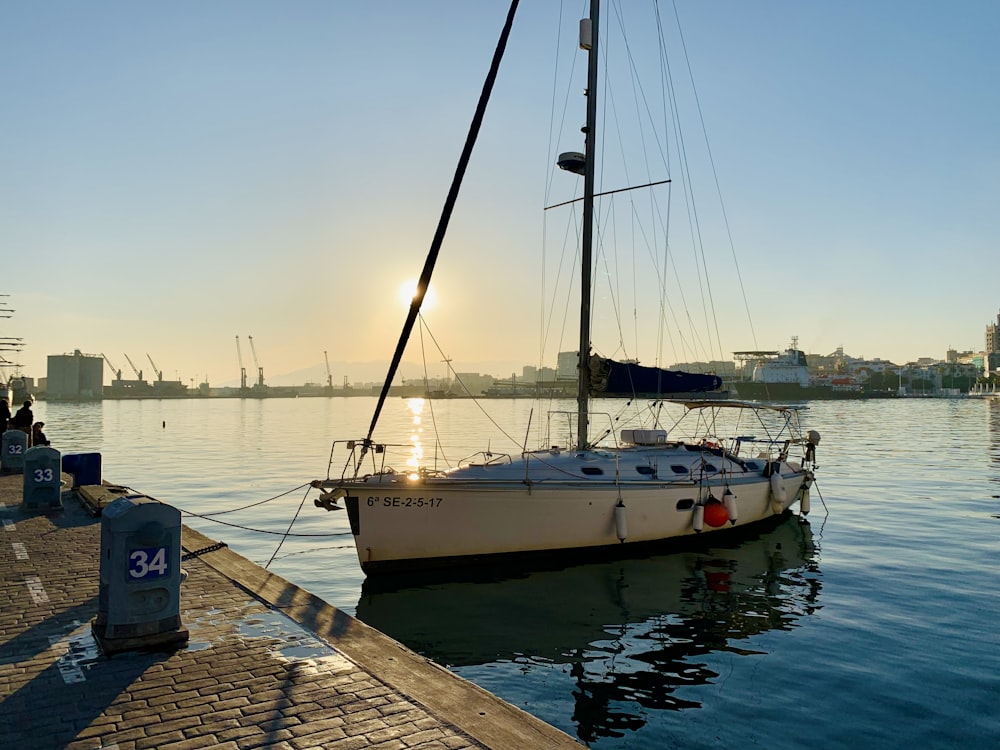 a sailboat is docked at a dock